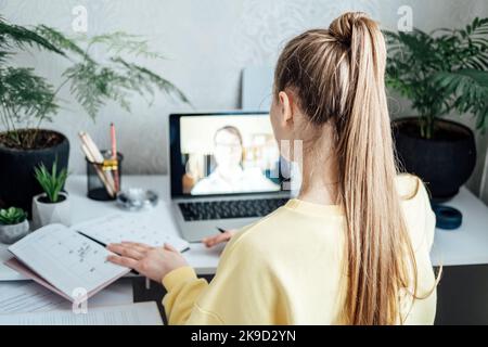Young woman business woman student teacher tutor having online virtual video call. Freelancer having video conference calling on laptop computer talk Stock Photo