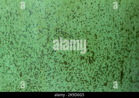 This image shows a mint green color abstract texture background of a macro photographed glazed ceramic stoneware surface. Stock Photo