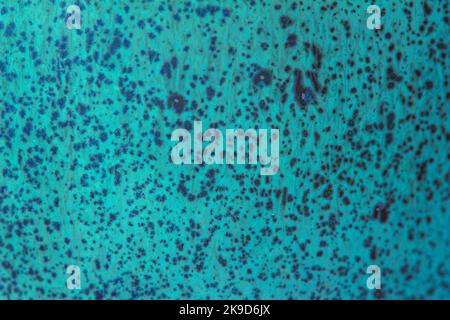 This image shows a turquoise blue color abstract texture background of a macro photographed glazed ceramic stoneware surface. Stock Photo