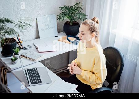 Tutoring, Homework Help, and Test preparation. Young woman speaking in front of camera for vlog as online tutor or couch. Earn extra money, money Stock Photo
