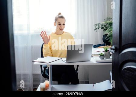 Tutoring, Homework Help, and Test preparation. Young woman speaking in front of camera for vlog as online tutor or couch. Earn extra money, money Stock Photo