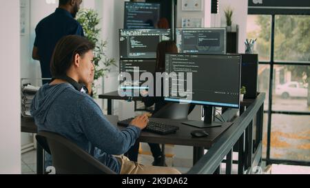 Asian software engineer working on security program with server code, typing system information on computer screen. Database programer writing code with algorithms, it language. Stock Photo