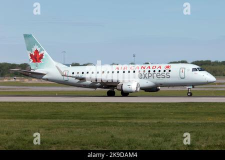 An Air Canada Express (Jazz Aviation) Embraer 170 on the runway of Montreal Pierre Elliott Trudeau Int'l Airport. Air Canada Express is a brand name of regional feeder flights for Air Canada that are subcontracted to other airlines. As of March 2021, Jazz Aviation is the sole operator of Air Canada Express. Stock Photo