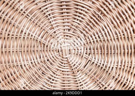 Circular weave rattan pattern, round rattan furniture background light brown texture, weave rattan texture and background. a fragment of a basket made Stock Photo