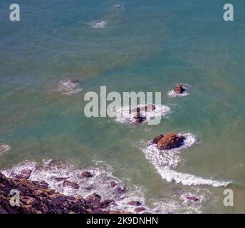 Waves and rocks in sea off coast with copy space Stock Photo
