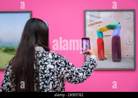 London, UK. 27th Oct, 2022. A guest takes pictures of Arielle Bobb-Willis, New Orleans, 2017. Invited guests and artists mingle and pose with the images. Private view of the new exhibition 'The New Black Vanguard: Photography Between Art and Fashion' at Saatchi Gallery in London, supported by Burberry. The exhibition features 15 international Black photographers and is a celebration of Black creativity both in-front of and behind the camera, running until Jan 22, 2023. Credit: Imageplotter/Alamy Live News Stock Photo