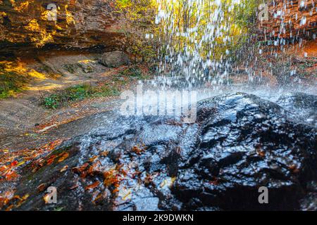 Natural waterfall , splashing water drops . Waterfall in autumn Stock Photo