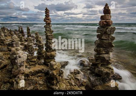 Rock Cairns are piled high and thickly along the Lake Michigan shore, Whitefish Dunes State Park, Door County, Wisconsin Stock Photo