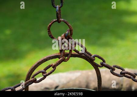 Old well bucket with rusty chain, life concept from a century ago. Stock Photo