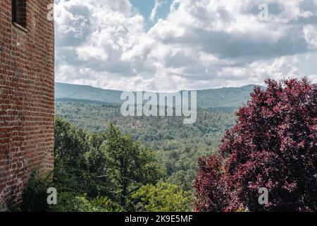 The Tuscan fields seen from the side of an immense brick wall Stock Photo