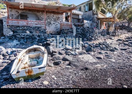 Old rusty boat on the shore in Santorini island Stock Photo