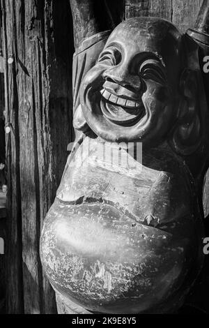 Close up of Happy and fat buddha Budai. Budai is Commonly Known as the Laughing Buddha-Alberni BC Canada-October 5,2022. Travel photo, nobody Stock Photo