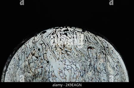 Virtual reality space with abstract multicolor psychedelic planet. Closeup Soap bubble like an alien planet on black background Stock Photo