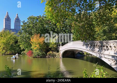 Central Park in foliage autumn colors, including the lake, boats and bridge in New York City, USA Stock Photo
