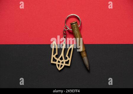 Flag of the Organization of Ukrainian Nationalists and the coat of arms of Ukraine and a bullet as a background, war Stock Photo