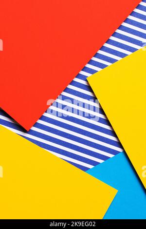 Abstract geometric fashion colored papers texture background. Yellow, red, blue and striped paper background. Top view, flat lay Stock Photo