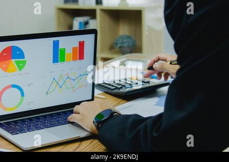 Businessman working at office with document on his desk.Paperwork graph report planning analyzing the financial and investment analysis concept. Stock Photo