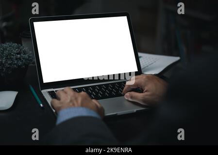 Business man using laptop computer looking with blank screen for mock up template background, business technology. Stock Photo