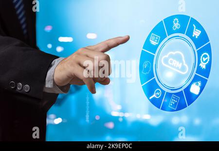 businessman pressing button on virtual screens CRM Customer relationship management concept. Stock Photo