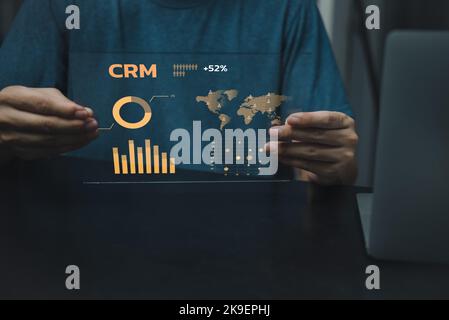 Business man holding screen virtual icon crm Customer relationship management. Business Internet Technology marketing solution Concept. Stock Photo