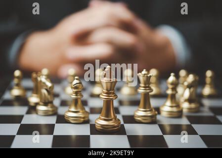Strategic planning and goals success business idea. Businessman looking at chess at the board. Stock Photo