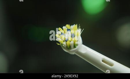 Used head of white electric toothbrush extreme close-up macro rotating accent part Stock Photo