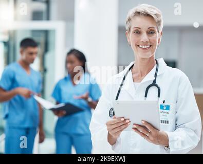 Senior woman, doctor and tablet with smile for medical research, innovation and medicine at the hospital. Portrait of elderly female healthcare Stock Photo