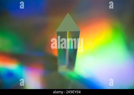 Glass prism on bright rainbow colors abstract background. Colorful polygonal multicolor banner. Stock Photo
