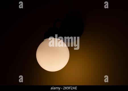 Lamp is in interior. Ball glows in dark. Lamp sphere. Details of light in room. Stock Photo