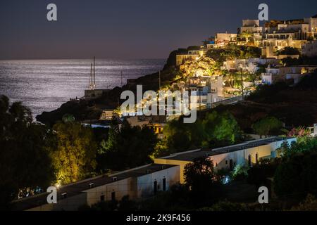 Ios, Greece - September 8, 2022 : View of beautiful and whitewashed illuminated hotel rooms overlooking the Aegean Sea in Mylopotas Ios Greece Stock Photo