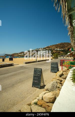 Ios, Greece - September 8, 2022 : A restaurant and beach bar in front of the Mylopotas beach serving breakfast, lunch and dinner Stock Photo