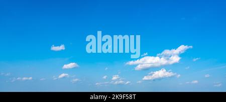 Blue panoramic sky background with small white clouds Stock Photo
