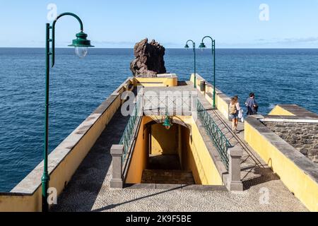 PONTA DO SOL, PORTUGAL - AUGUST 27, 2021: This is a two-tier stone pier of a small village on the coast of Madeira. Stock Photo