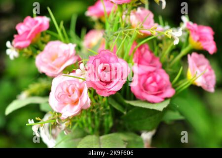 Plastic flower arrangements of various colors in pots selective focus Stock Photo