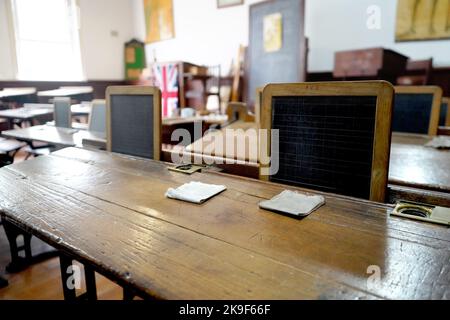 Old historical classroom with wooden desks and chalkboards Stock Photo