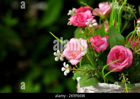 Plastic flower arrangements of various colors in pots selective focus Stock Photo