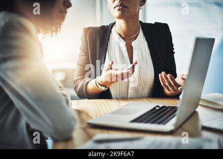 Planning is the most important step to success. Closeup shot of two businesswomen working together on a laptop in an office. Stock Photo