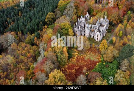 The ruins of Dunalastair House, near Pitlochry, Perthshire, are surrounded by trees displaying their autumn colours. Picture date: Friday October 28, 2022. Stock Photo