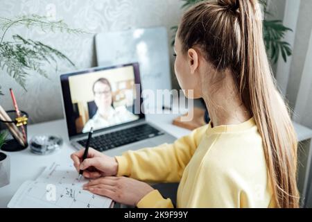 Young woman business woman student teacher tutor having online virtual video call. Freelancer having video conference calling on laptop computer talk Stock Photo