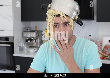 Chaotic chef trying to make some pasta Stock Photo