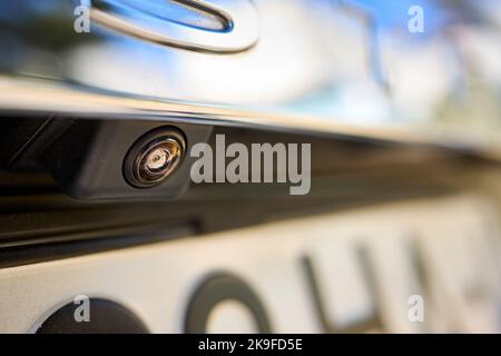 Luxury car rear view camera for parking assistance selective focus close up with sunflare and copyspace. Concept of safety car driving while parking Stock Photo