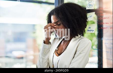 I cant deal with this right now. a young businesswoman looking stressed out in her office. Stock Photo