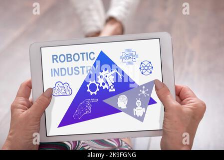 Robotic industry concept shown on a tablet held by a woman Stock Photo