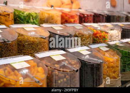 Assorted dried fruits in plastic containers in the store close-up Stock Photo