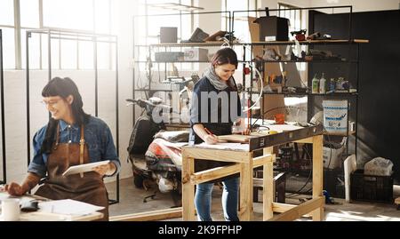 Working with wood. two attractive young creative female artisans working in their workshop. Stock Photo
