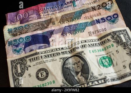 Big amount of Nigerian notes and a doller bill. Nigerian banknotes close-up. Rich life conceptual Stock Photo