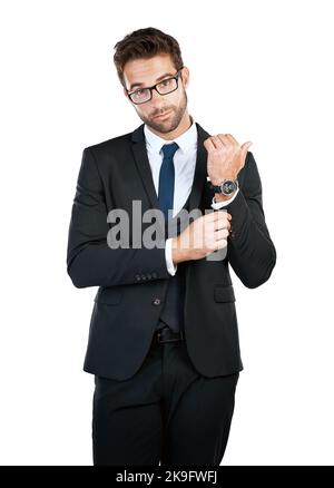 Adjusting his cuff links. Studio shot of a handsome young businessman posing against a white background. Stock Photo