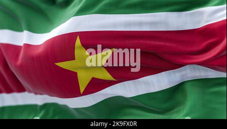 Close-up view of Suriname national flag waving in the wind. The Republic of Suriname is an independent state of South America. Fabric textured backgro Stock Photo