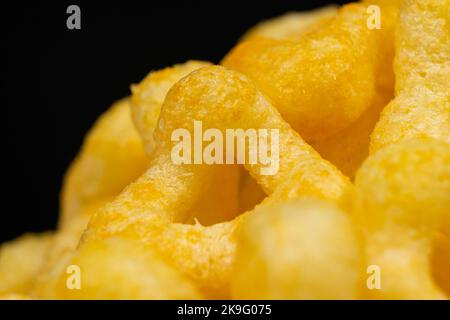 Delicious crispy corn chips with spices on a black background. Stock Photo