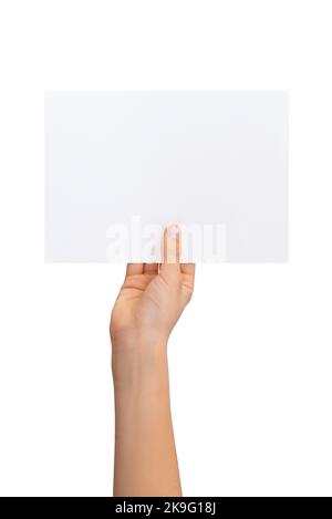 Hand holding blank flyer, sheet of paper in horizontal position with isolated background Stock Photo